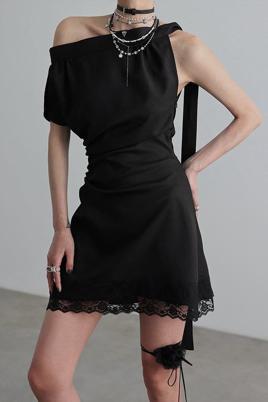 Woman wearing a black asymmetric one-shoulder dress from Belle Vestige's Bold & Confident Collection. Featuring lace details and modern styling, this vintage-inspired piece exudes confidence and elegance, perfect for bold fashion statements.